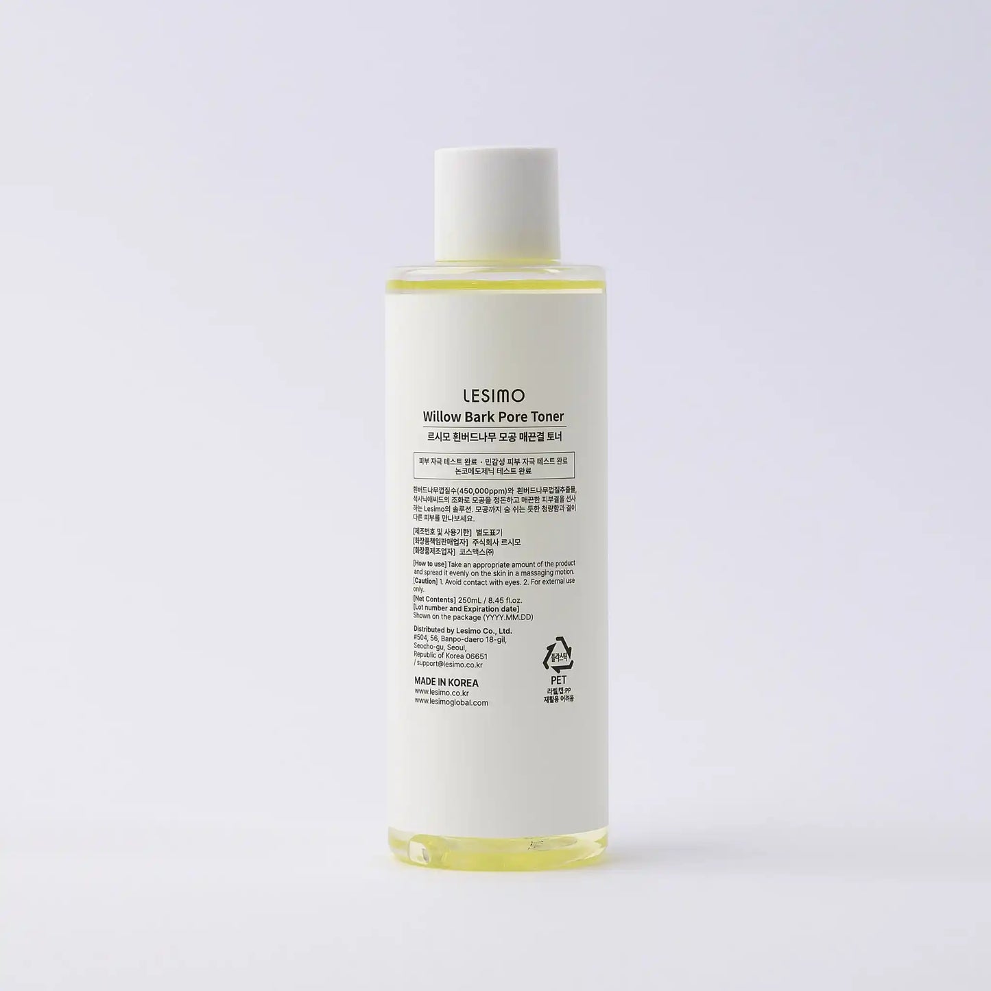 Skincare bottle with label on a light gray background