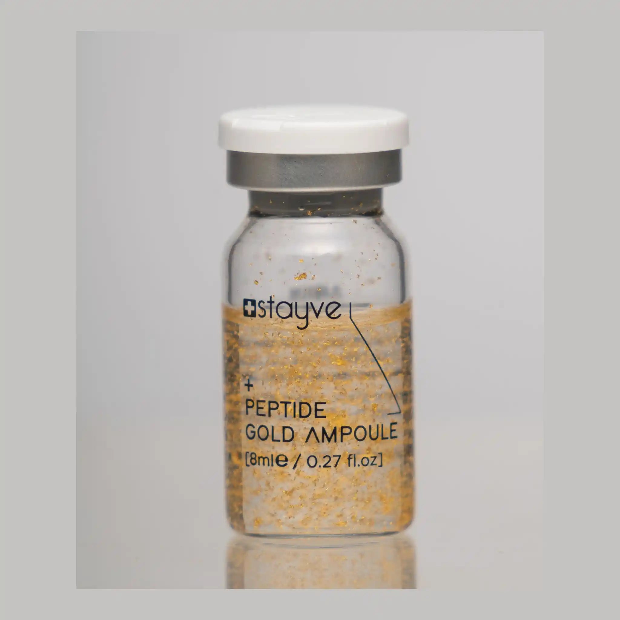 Peptide gold ampoule bottle with 'stayve' branding on a gray background