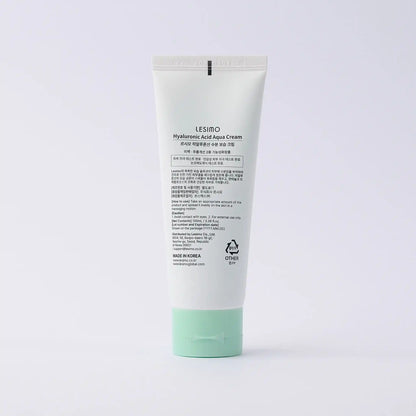Tube of cream with green cap on a white background
