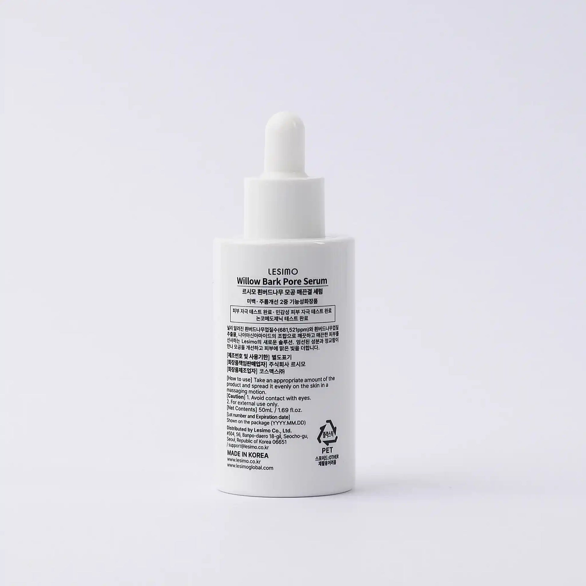 White serum bottle with text on a light gray background