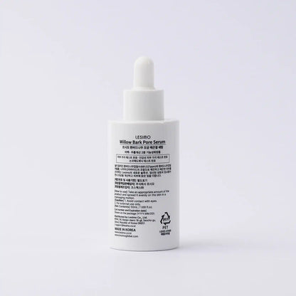 White serum bottle with text on a light gray background